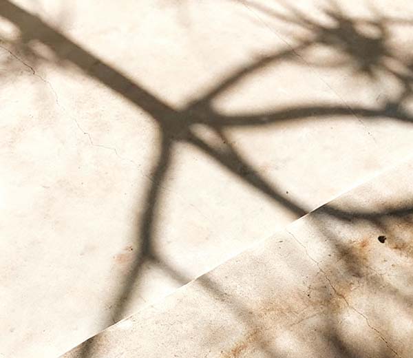 Abstract shadow patterns on a textured surface.